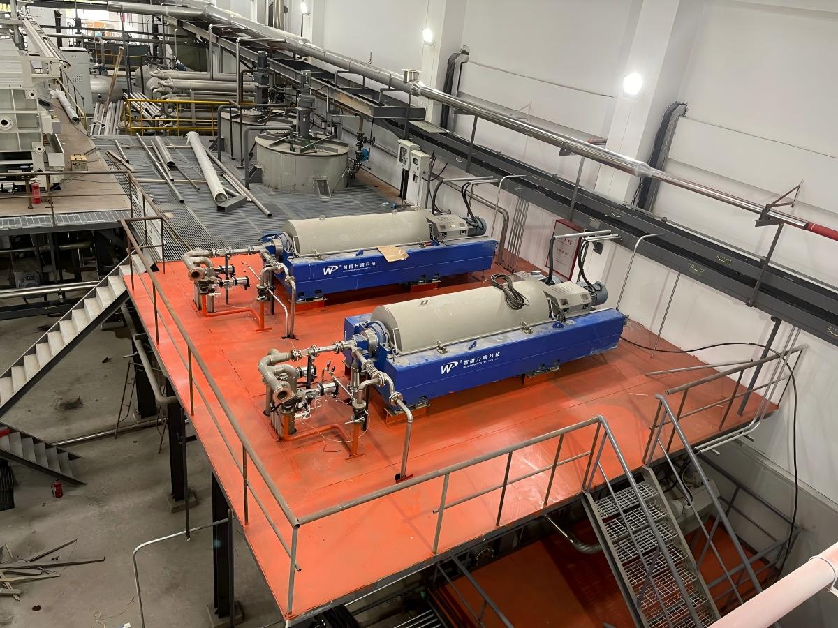 Two LWS580×2400CX three-phase decanter centrifuges installed on an elevated platform