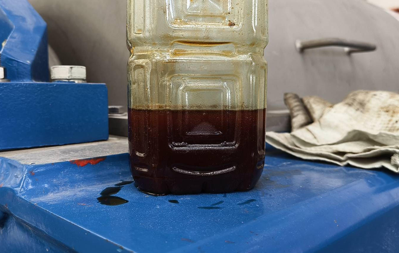 Recovered used cooking oil discharged from three-phase decanter centrifuge heavy liquid phase outlet