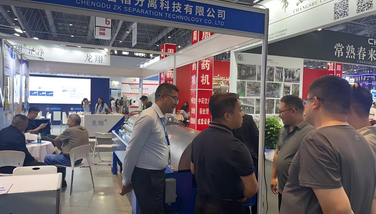 Visitors examining the ZK SEPARATION decanter centrifuge at the CIPM Xiamen booth