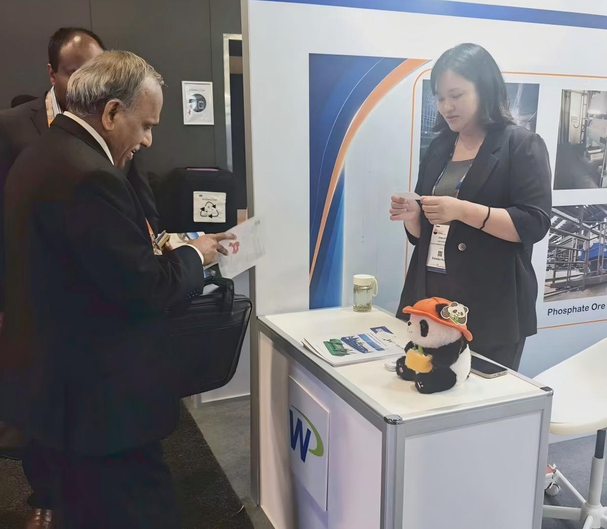 A visitor reviewing ZK SEPARATION product materials with an international sales representative at IMARC 2026